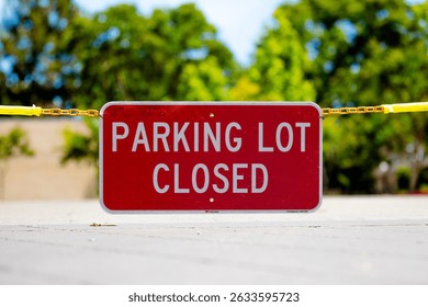 Parking Lot Closed red rectangular sign suspended on a chain blocking access to an empty public parking lot at a corporate campus, sunny day, no people, copy space