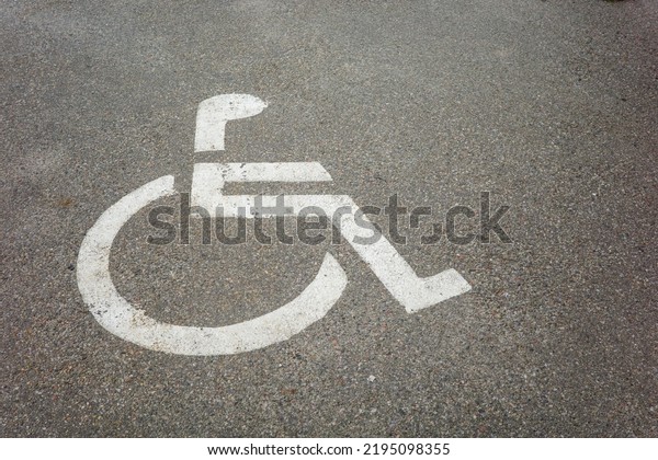 parking for the disabled, road\
markings for cars on the asphalt of the supermarket, shot\
close-up