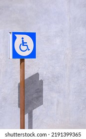 Parking Disabled Wheelchair Sign On Loft Concrete Wall Outside Of Building In Vertical Frame