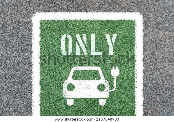 Parking for electric
cars only with symbols. Electric vehicle charging station with
electric plug icon.