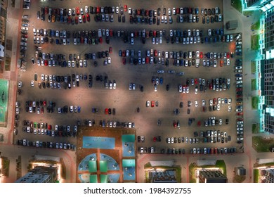 Parking Lot Full Of Cars On The Modern City Courtyard At Night. Aerial Top View