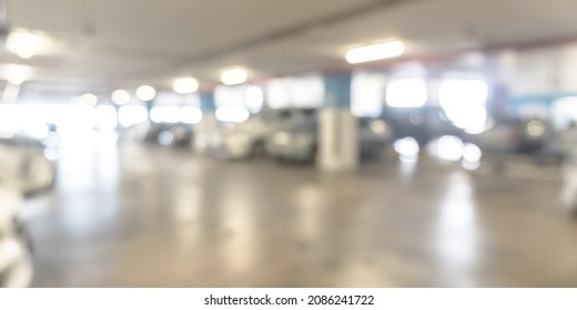 Parking Garage Blur Background With Blurry Building Interior Lot Space And Bright Illumination Light Bokeh For Automotive Vehicle And Car Insurance Safety Concept