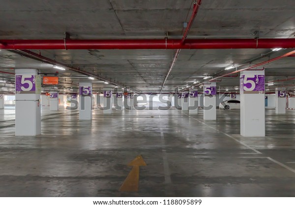 A parking\
lot garage with car is an area that is assigned to parking,Empty\
Industrial Shed for Parking\
Lot.