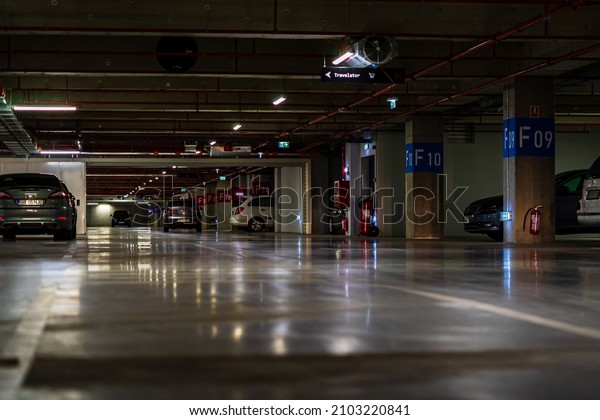 Parking garage interior with
a few parked cars. Underground parking garage in Bucharest,
Romania, 2022