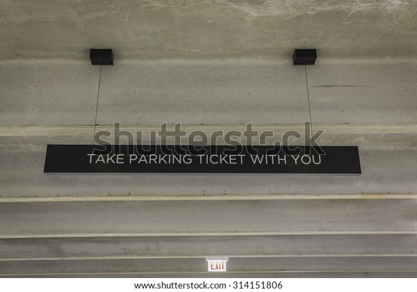 Parking garage ticket\
sign from low angle