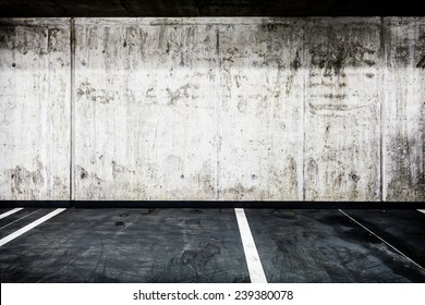 Parking garage underground interior background or texture. Concrete grunge wall and asphalt road, industrial retro vintage interior. - Shutterstock ID 239380078