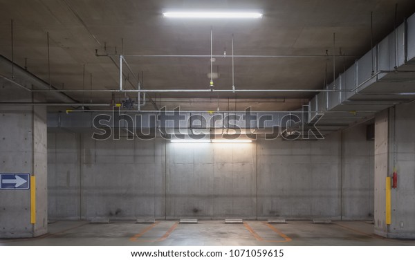 Parking garage underground interior, neon\
lights at night\
\
