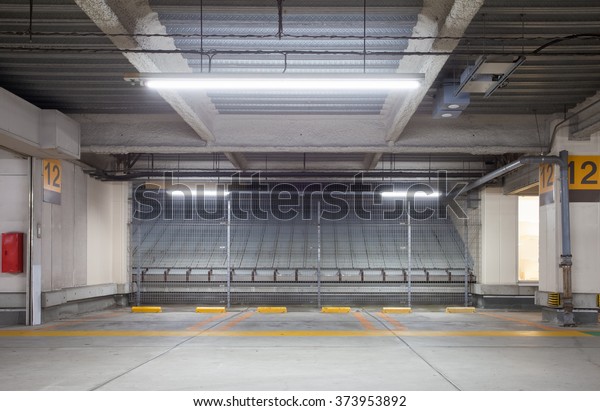 Parking garage underground interior, neon lights at\
night 