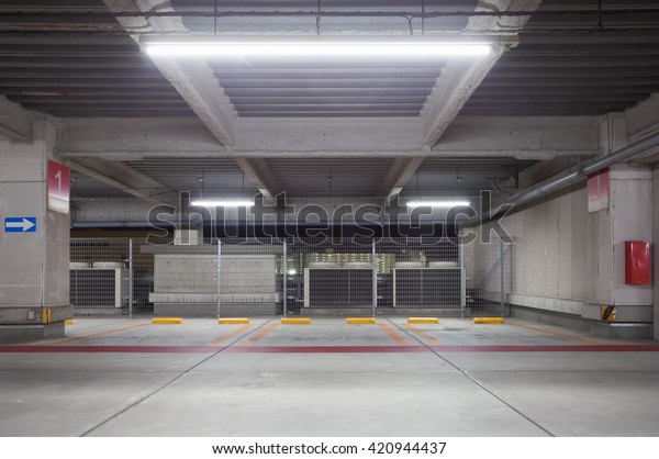 Parking garage underground interior, neon\
lights at night\
\
