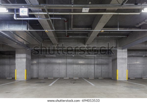 Parking garage underground\
interior with neon lights Empty Parking lot Car park at underground\
building