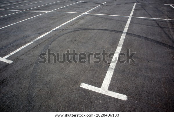 Parking kiosks in the parking\
lot, marked with white lines. Empty parking lot. Outdoor car park\
with freshly painted kiosk lines. Outdoor parking on an asphalt\
road