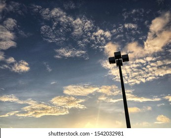 Parking Lot Light Pole With Cloudy Sky At Sunset