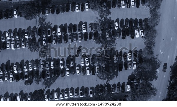 Parking lots full\
of vehicles. Birds eye\
view.