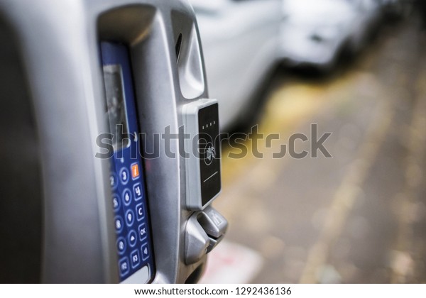 Parking\
machine or Parking meters with electronic payment in the city\
streets and a row of cars in Sydney\
Australia.
