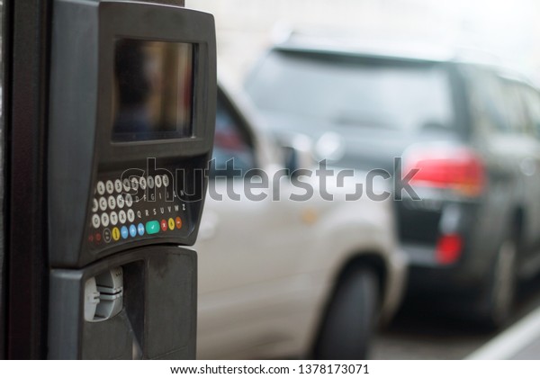 Parking meter. Car and car Parking with\
electronic payment.