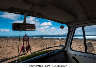 parking near the ocean with a minivan. Dreamcatcher and ocean with waves outside, islands in background. Alternative travel concept. - Powered by Shutterstock