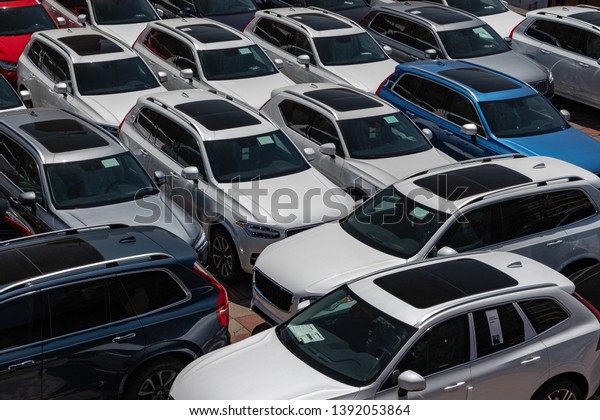 parking lot of new cars\
at a dealership