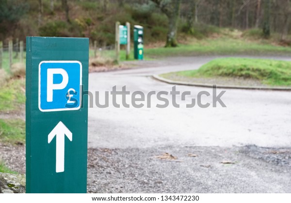 Parking payment icon\
and sign at car park
