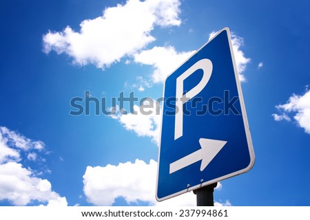 parking sign with blue sky and clouds