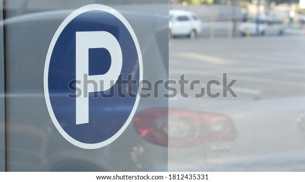 Parking lot sign as symbol of traffic difficulties\
and transportation issues in busy urban areas of USA. Public paid\
parking zone in downtown of San Diego, California. Limited space\
for cars in city.