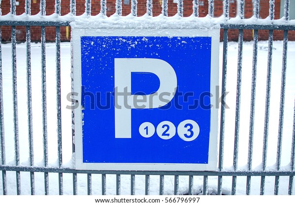 Parking sign with three hours of\
parking time. Actual street parking sign in a city. Winter\
season