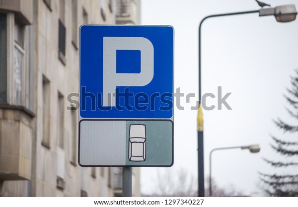 Parking sign.\
Vehicles take up way too much space in cities. Metropolis parking\
problems. Cars became biggest problem for urban ecology due\
emission and environmental\
pollution.