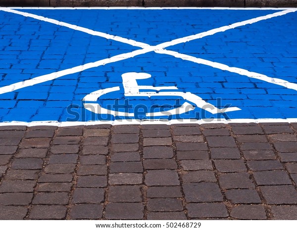 Parking\
space for disabled people - painted on the\
street