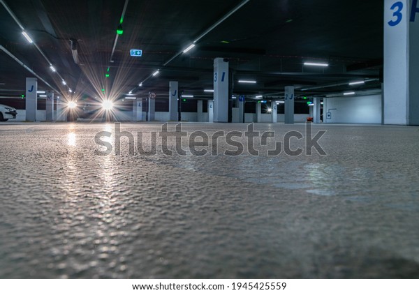 Parking space. Empty road asphalt background. Car\
lot parking space in underground city garage. Hidden underground\
carpark