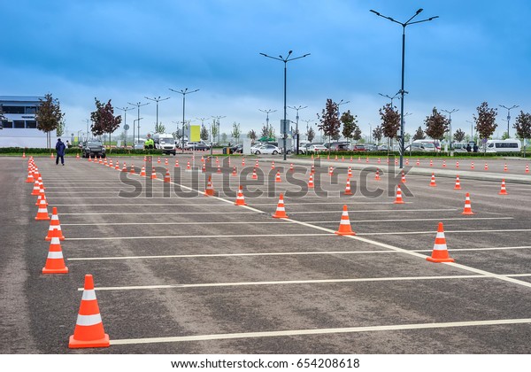Parking\
space. Open parking for cars. Signal road\
cones.