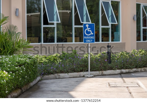 Parking space
reserved for Reserved shoppers in a retail parking lot . Parking
for disabled or wheelchair . A sign indicates reserved parking for
disabled people in a car park.
