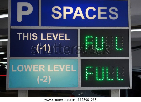 Parking spaces digital indication sign. Broken\
green light on word FULL, missing 1 letter. Information, repair,\
maintenance concept.