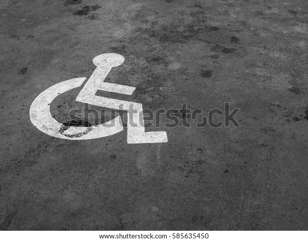 The parking spaces for disabled people on the street\
in the parking lot.