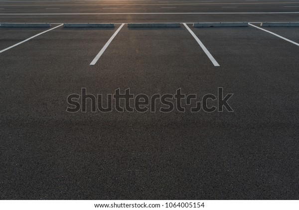 Parking stalls in a
parking lot, marked with white lines. Empty parking lot background
with copy writing
space.