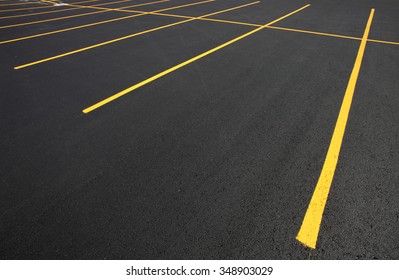 The parking stalls in a parking lot, marked with yellow lines. - Shutterstock ID 348903029