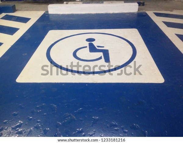 Parking\
lot symbol for the disabled in the mall. Handicapped parking in the\
parking lot. Parking for the disabled in\
public.