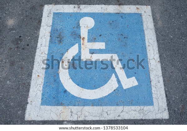 Parking\
symbol of disabled people on the Concrete\
road.