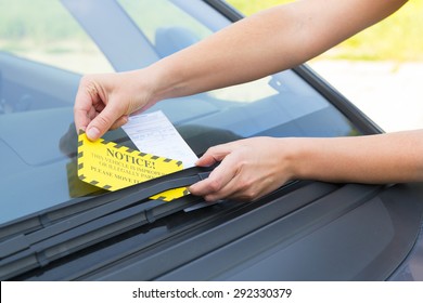 Parking ticket placed under windshield wiper
