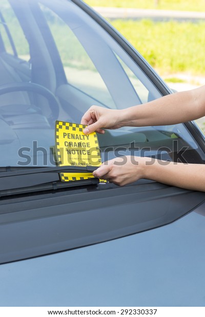 Parking ticket\
placed under windshield\
wiper
