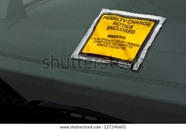 Parking\
ticket stuck on car windscreen a penalty or\
fine