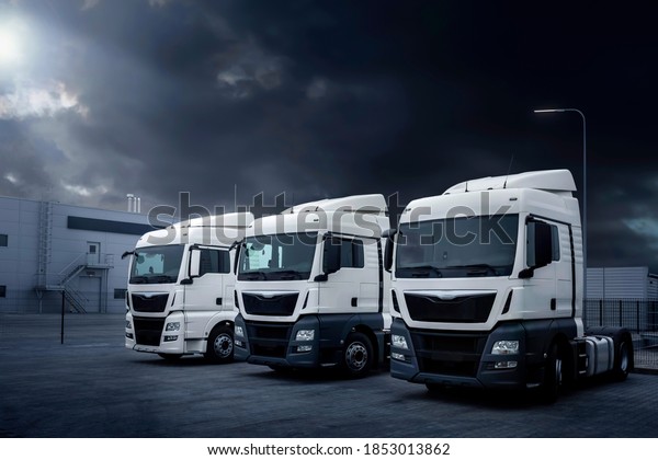 Parking lot with trucks for delivery\
and transportation of goods. Trucks are parked in the parking lot\
at night. Logistics and transport concept, car\
service