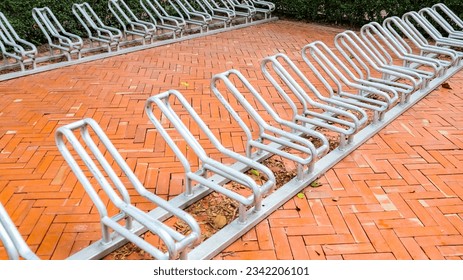 ฺBicycle parking, a wrought iron frame to lock bicycle wheels in a park. Wrought iron bike parking.