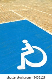 parkingspace for disabled with wheelchair symbol on blue paint