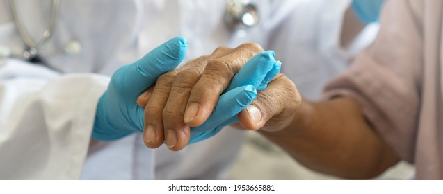 Parkinson And Alzheimer Female Senior Elderly Patient With Physician Doctor In Hospice Care.