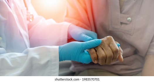 Parkinson And Alzheimer Female Senior Elderly Patient With Caregiver In Hospice Care. Doctor Hand With Stethoscope Check Up Older Woman People. Old Aging Person Seeing Medical Physician In Hospital.