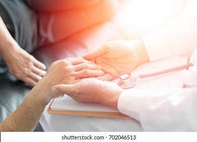 Parkinson And Alzheimer Female Senior Elderly Patient With Caregiver Doctor In Hospice Care.