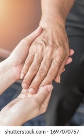 Parkinson Disease Patient, Alzheimer Elderly Senior, Arthritis Person's Hand In Support Of Nursing Family Caregiver Care For Disability Awareness Day, National Care Givers Month, Ageing Society 