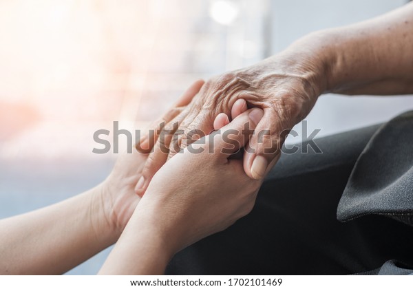 Parkinson disease patient, Alzheimer elderly senior,\
Arthritis person\'s hand in support of nursing family caregiver care\
for disability awareness day, National care givers month, ageing\
society 