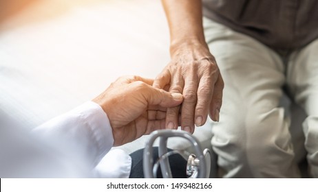 Parkinson's Disease Elderly Patient, Arthritis Hand Pain Or Mental Health Care Concept With Geriatric Doctor Consulting Examining Senior Aged Adult In Medical Exam Clinic Or Hospital