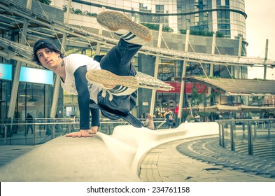 Parkour athlete jumping over a handrail - Free runner performing tricks in a urban settlement - Parkour,free running,youth,sport and lifestyle concept - Powered by Shutterstock