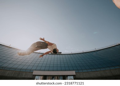 Parkour. Athlete performs tricks in the city. - Powered by Shutterstock